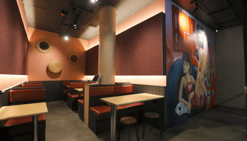 Custom graffitti wall art, earth and terracotta colour palette and welcoming dining area for this hospitality fit out for Senn Noods